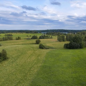 View from Siberija observation tower over wide meadows and a distant lake View from Siberija observation tower over wide meadows and a distant lake