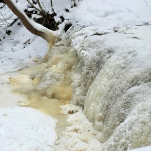 Winter view of Ivande lower waterfall with frozen water flow Winter view of Ivande lower waterfall with frozen water flow