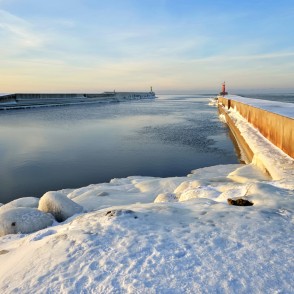 Winter sunset at Pavilosta pier and frozen sea Winter sunset at Pavilosta pier and frozen sea