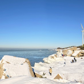 Liepaja northern forts in winter with a wind turbine and visitors Liepaja northern forts in winter with a wind turbine and visitors