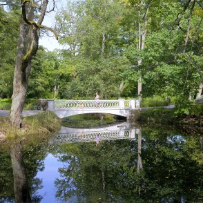 Small bridge in Kemeri resort park reflected in water Small bridge in Kemeri resort park reflected in water