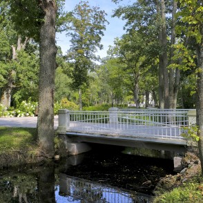 White bridge in Kemeri resort park among trees White bridge in Kemeri resort park among trees