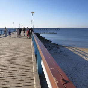 Walking on Palanga Sea Pier with views of the beach and calm sea Walking on Palanga Sea Pier with views of the beach and calm sea