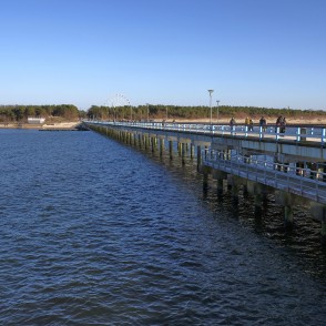 View along Palanga Sea Pier over the water with coastline and people View along Palanga Sea Pier over the water with coastline and people
