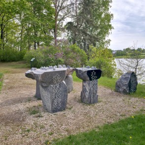 Granite Memorial Ensemble with Latvian Folk Patterns on a Riverside Hillside Granite Memorial Ensemble with Latvian Folk Patterns on a Riverside Hillside