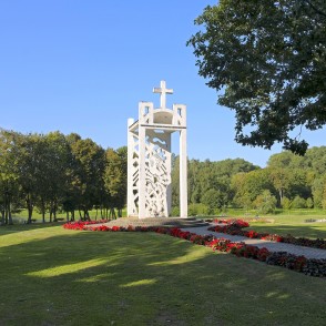 Memorial monument with cross silhouette in a landscaped Skuodas city park Memorial monument with cross silhouette in a landscaped Skuodas city park