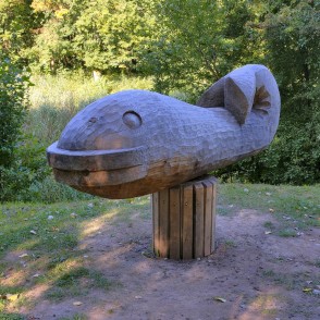 Wooden fish sculpture along a nature trail in a Skuodas city park Wooden fish sculpture along a nature trail in a Skuodas city park