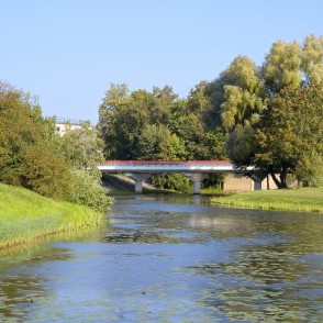 Bārta River with a road bridge and landscaped park banks Bārta River with a road bridge and landscaped park banks