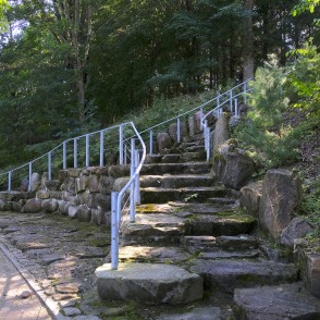 Stone steps with metal railings in a park setting Stone steps with metal railings in a park setting