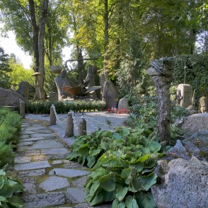 Stone pathway in a garden with sculpture and decorative boulders Stone pathway in a garden with sculpture and decorative boulders