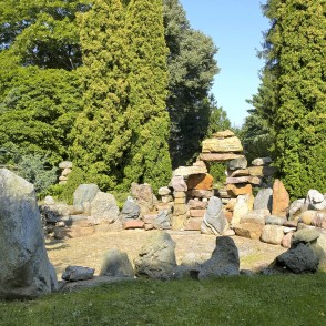 Rock composition with boulders and conifer backdrop in a sunny garden Rock composition with boulders and conifer backdrop in a sunny garden