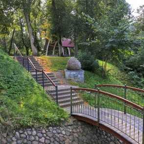 Footbridge and stairs with sculpture in Salantai City Park greenery Footbridge and stairs with sculpture in Salantai City Park greenery