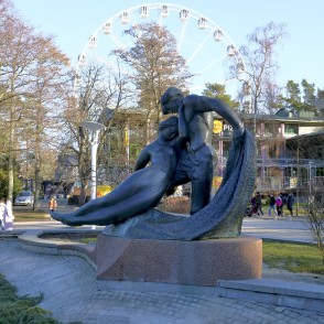 Sculpture “Jūratė and Kastytis” with a Ferris wheel in the background in Palanga Sculpture “Jūratė and Kastytis” with a Ferris wheel in the background in Palanga