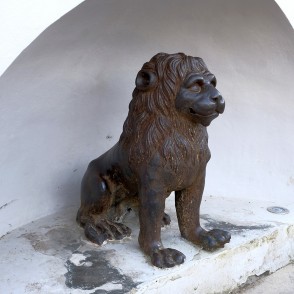 Lion sculpture in an alcove by the stairs at the Amber Museum entrance Lion sculpture in an alcove by the stairs at the Amber Museum entrance